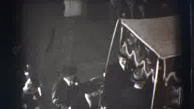 Joliet Illinois USA (1941): Woman Holding Flower Walks Through Doorway Of White