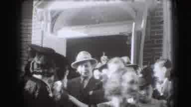 Joliet Illinois USA (1941): Woman Wearing Black Hat Walks Away From Brick Building