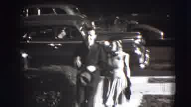 Joliet Illinois USA (1941): A Man And A Woman Walking From The Street Onto The