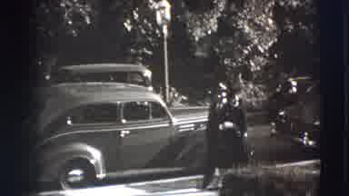 Joliet Illinois USA (1941): Well Dressed Woman And Man Walking Down A Sidewalk