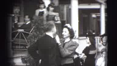 Joliet Illinois USA (1941): Woman Grooms Man's Face And He Fixes His Hair In Front