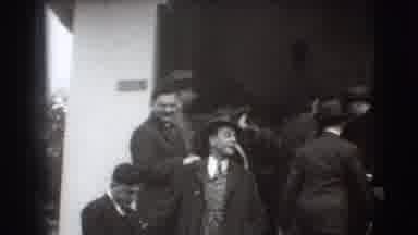 Joliet Illinois USA (1941): Men And Women In Formal Attire Stand Under A Raised