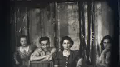 Joliet Illinois USA (1941): Man Walking Through A Basement With Other People