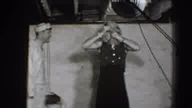Joliet Illinois USA (1941): Woman Removing Something From Under Her Shirt And A