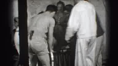 Joliet Illinois USA (1941): Man Wearing White Jumpsuit Moves Large Metal Object