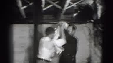 Joliet Illinois USA (1941): Man Wearing White Shirt Tries Placing White Cloth On