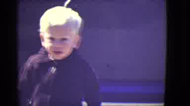 East Orange New Jersey (1946): A Blond Toddler Boy In A Zip-Up Jacket Walks And