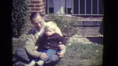 East Orange New Jersey (1946): Adult With Kid Sitting On The Front Yard Of A Brick
