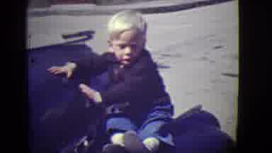 East Orange New Jersey (1946): Little White Boy Sits Down Holding Onto Something
