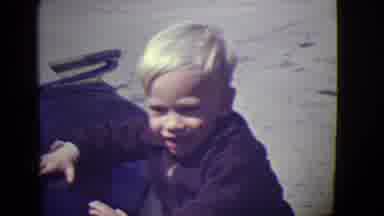 East Orange New Jersey (1946): Little Blonde Boy Slapping The Hood Of A Car Smiles