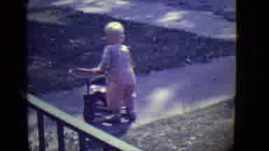 East Orange New Jersey (1946): A Baby With Mother Is Playing With His Toy Cycle