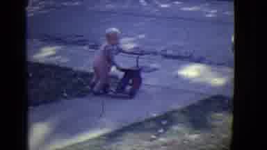 East Orange New Jersey (1946): A Small Child Pushing A Tricycle On A Small Slope