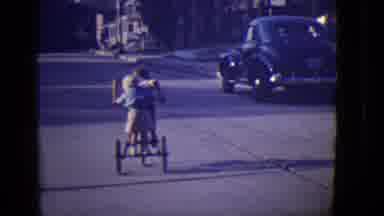 East Orange New Jersey (1946): An Older Boy Bicycling A Big Tricycle With A Little