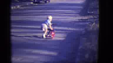 East Orange New Jersey (1946): Toddler Boy Pushing Off Red Tricycle Playing