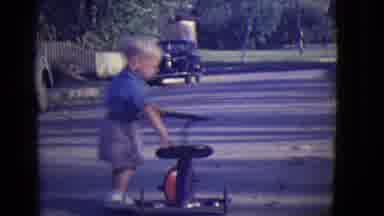 East Orange New Jersey (1946): Little Boy Pushing His Little Red Metal Tricycle
