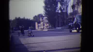 East Orange New Jersey (1946): Toddler Watches Boy Ride Tricycle Down Street On A