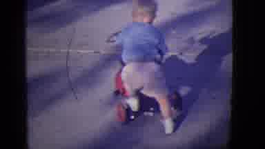East Orange New Jersey-1946: A Small Blond Boy Scoots On A Tricycle In A Driveway
