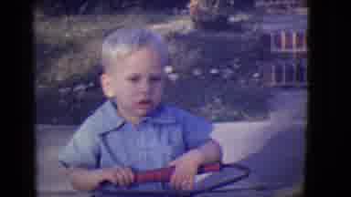 East Orange New Jersey (1946): Small Boy Talking Hold Toy Jump Rope Outside