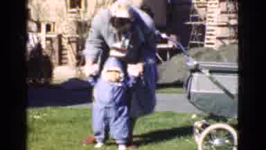 QUEBEC CANADA-1946: Bundled Mother Helps Toddler Take First Steps