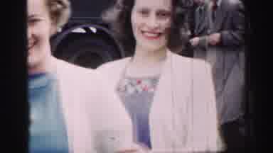 UNITED KINGDOM-1952: Women in Blue Dresses and White Sweaters Talk at Outdoor Gathering with Man in Kilt