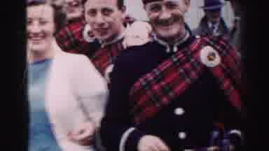 United Kingdom (1952): Men In Plaid Smile Next To Supportive Women At A Cultural