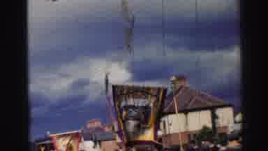 UNITED KINGDOM-1952: A Group Of People Carry Exotic Flags In A Parade Towards A