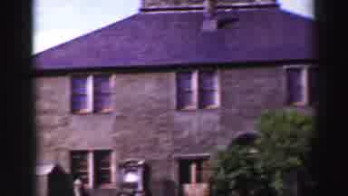 UNITED KINGDOM-1952: An Old Stone Building With A Weather Vane On Top