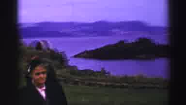 UNITED KINGDOM-1952: Woman Standing On Hill Overlooking Island