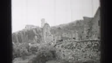 United Kingdom (1952): A Black And White Video Of Old Buildings With Bushes Next