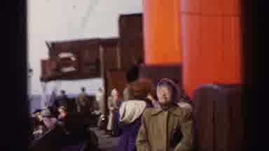 UNITED KINGDOM-1952: Passengers On A Ship Voyage With Mountain Coastline