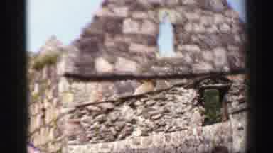 United Kingdom (1952): Well Dressed People Walk And Talk Around Stone Ruins Close