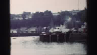 United Kingdom (1952): Men On The Dock Watch A Boat Sail Past The Harbour