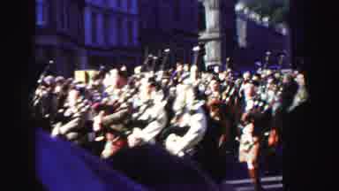 UNITED KINGDOM-1952: Scottish Bagpipers Marching In Town Parade