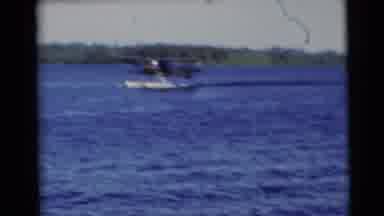 Baraboo Wisconsin USA-1953: Seaplane Gliding Across Calm Blue Lake Waters