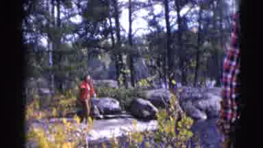 Baraboo Wisconsin USA (1953): Woman Wearing Red Coat Stands Next To Grey Rocks On