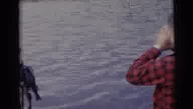 Baraboo Wisconsin USA (1953): Man Wearing Red Plaid Shirt Looks At Second Man