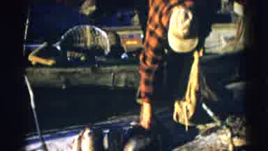 Baraboo Wisconsin USA (1953): Fisherman Gathering His Catch Into A Bag