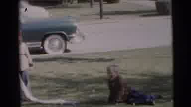 Baraboo Wisconsin USA (1953): Two Children Playing Outside On Grass On A Sunny Day