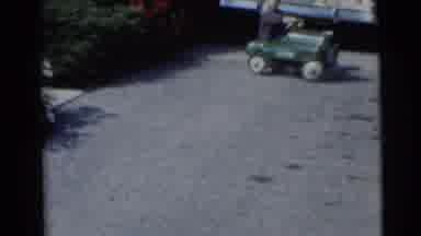 Baraboo Wisconsin USA (1953): Boy Pulling A Wagon With A Bike And Driving A Toy