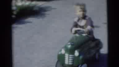 Baraboo Wisconsin USA (1953): A Young Boy Smiles With Joy As He Drives In His Toy