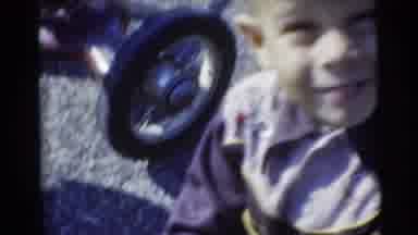 Baraboo Wisconsin USA (1953): Little Boy Smiling Riding Toy Tricycle Around Front