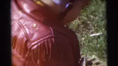 Miami Florida (1956): A Little Child With A Coat And Cap On Is Moving Around On