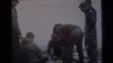 Miami Florida (1956): People Outside Near Water Around A Campfire On A Cloudy Day