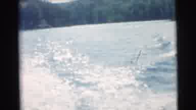 Miami Florida (1956): Man Wearing Red Plaid Shirt Unloads Axe From Rowboat On A