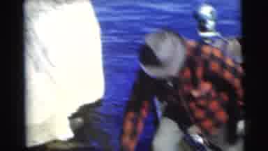 Miami Florida (1956): Man On Fishing Trip Wearing Flannel Catches Fish In Rowboat