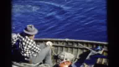 Miami Florida (1956): A Man Guides A Boat From The Back While Another Fetches