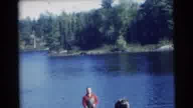 Miami Florida (1956): Two Caucasian Men Fish On A Boat In Blue Water