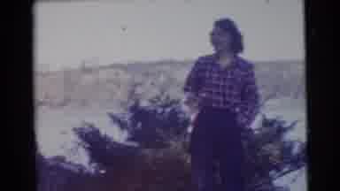 Miami Florida (1956): A Woman Standing In The Countryside Near A Fire Pit With