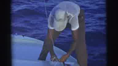 Miami Florida (1956): Man Ties Lines On The Boat As The Waves Make The Boat Bob Up