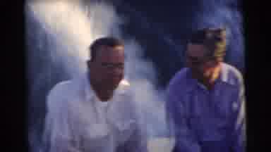 Miami Florida (1956): Two Men In Glasses Sitting On The Back Of A Speed Boat As It